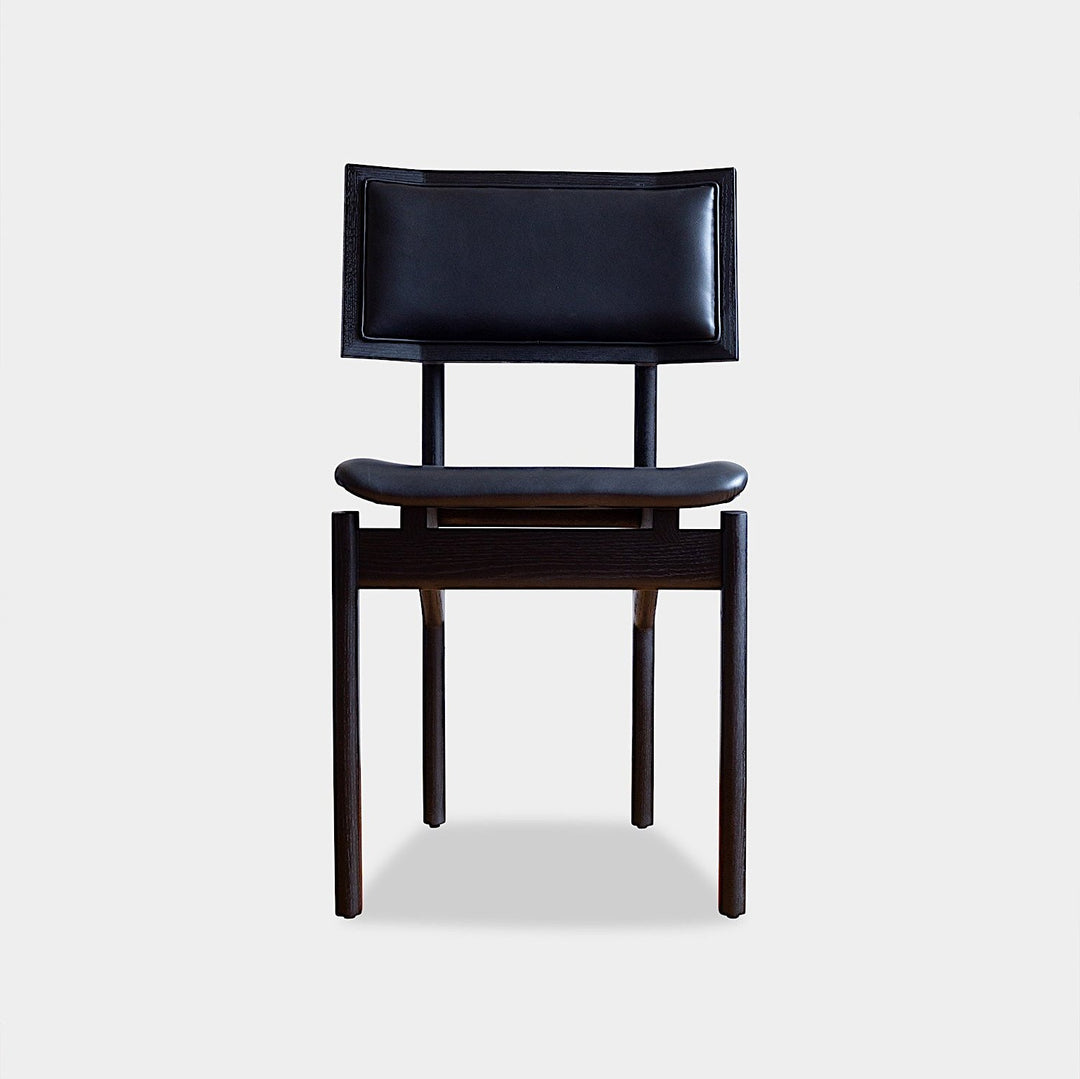 The KUNAI Dining Chair by Earl Home is handcrafted to order, featuring a solid wood frame, brown leather seat, and woven backrest.