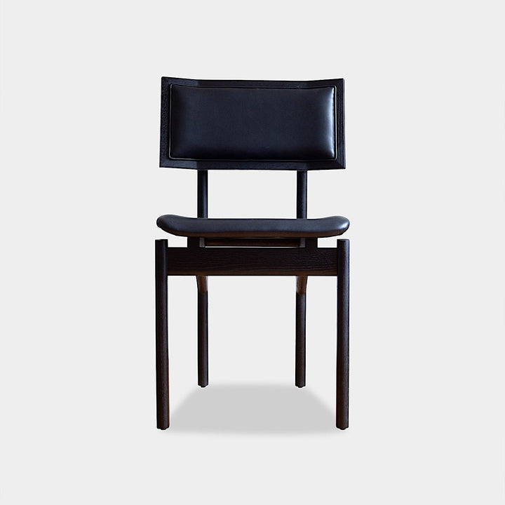 The KUNAI Dining Chair by Earl Home is handcrafted to order, featuring a solid wood frame, brown leather seat, and woven backrest.