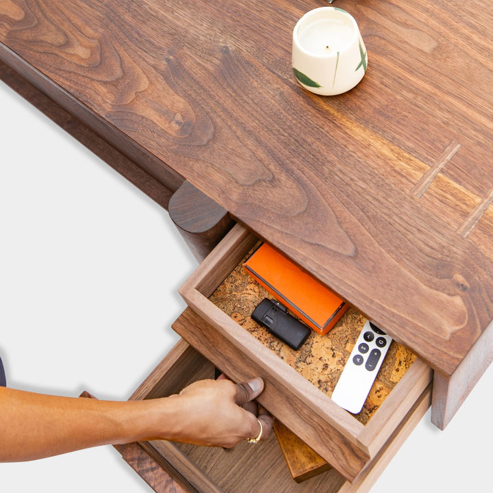 This LAPILO Coffee Table from Earl Home Designed by Chris Earl is solid wood constructed with hand cut joinery. With drawers on both the front and back, it’s not only visually appealing but also incredibly practical, making it an ideal choice for a game table or a multi-functional living room space. This table comes in walnut, maple, white oak, ebonized oak and is custom made in any size or shape desired.