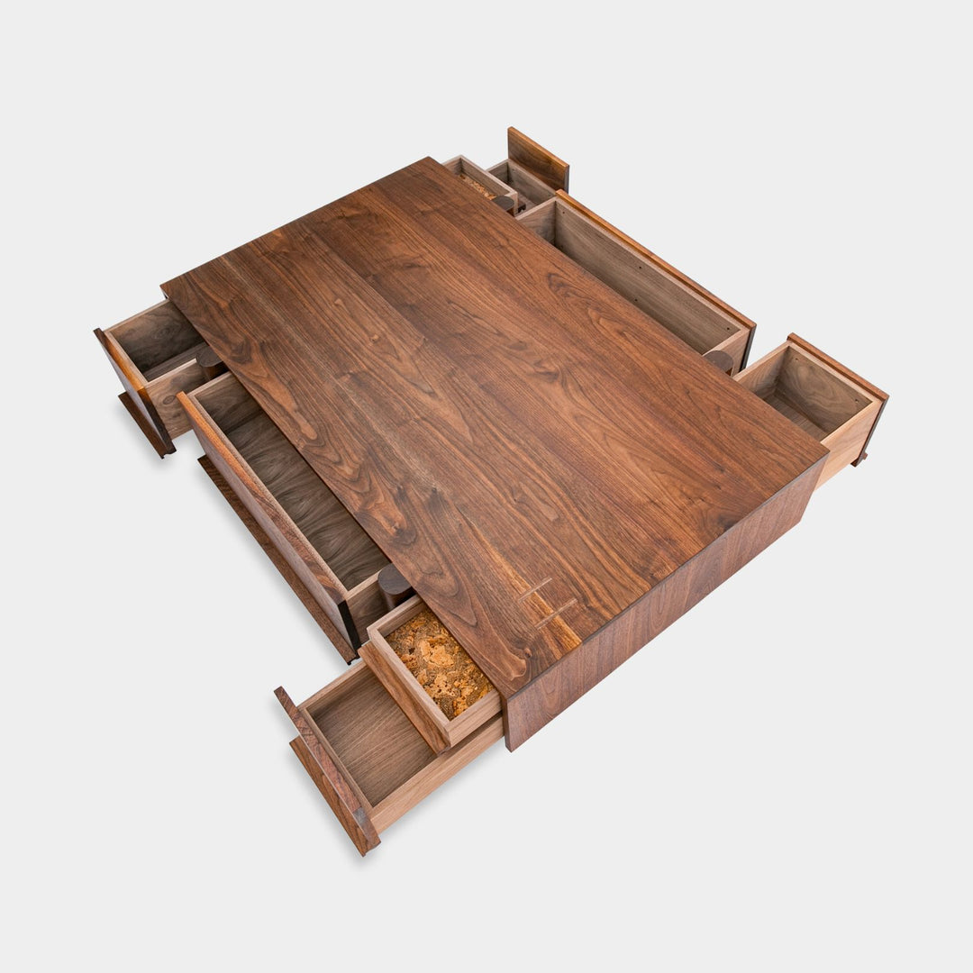 This LAPILO Coffee Table from Earl Home Designed by Chris Earl is solid wood constructed with hand cut joinery. With drawers on both the front and back, it’s not only visually appealing but also incredibly practical, making it an ideal choice for a game table or a multi-functional living room space. This table comes in walnut, maple, white oak, ebonized oak and is custom made in any size or shape desired.