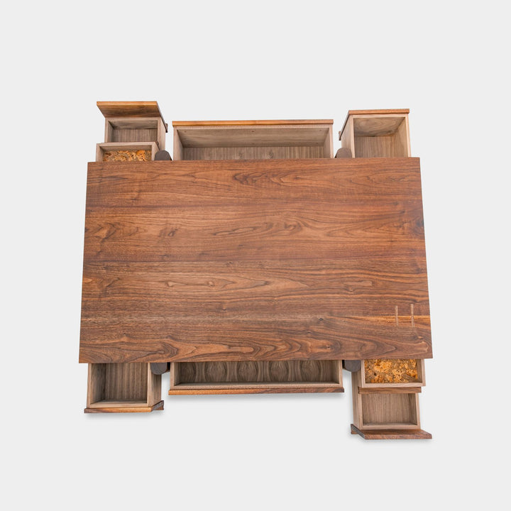 This LAPILO Coffee Table from Earl Home Designed by Chris Earl is solid wood constructed with hand cut joinery. With drawers on both the front and back, it’s not only visually appealing but also incredibly practical, making it an ideal choice for a game table or a multi-functional living room space. This table comes in walnut, maple, white oak, ebonized oak and is custom made in any size or shape desired.