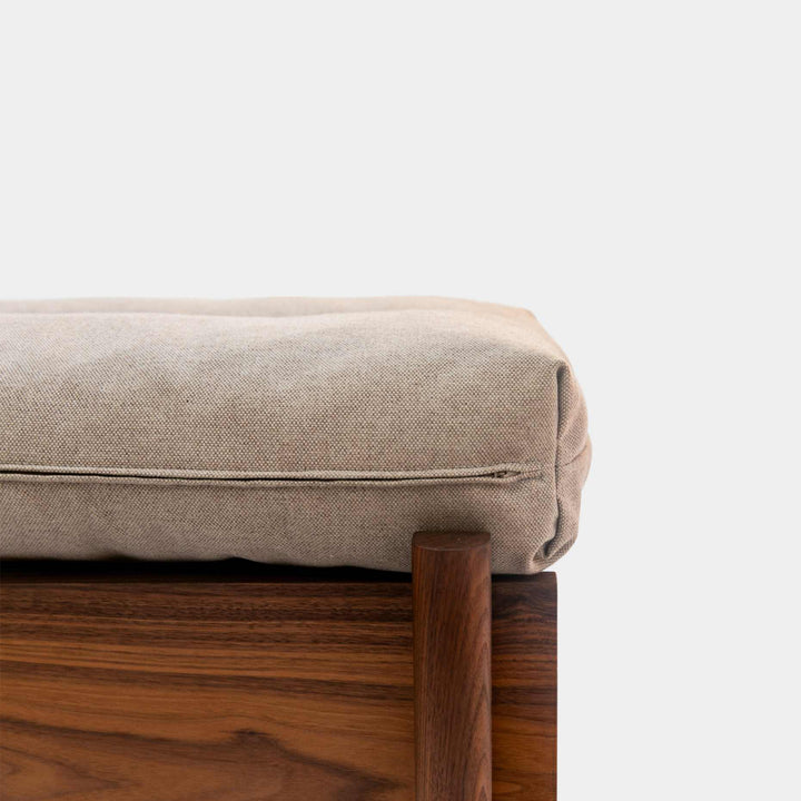 This EARL handmade dog bed has a solid wood base with a hidden drawer, and a custom detachable cushion upholstered in Sunbrella Blend Sand. We offer various fabrics and customers own fabric is encouraged as well. The base can be made in walnut, white oak, or ebonized oak and custom sizing is also available.