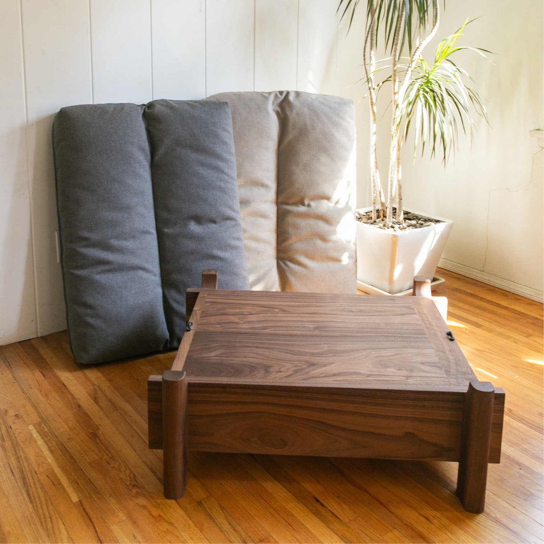 This EARL handmade dog bed has a solid wood base with a hidden drawer, and a custom detachable cushion upholstered in Sunbrella Blend Sand. We offer various fabrics and customers own fabric is encouraged as well. The base can be made in walnut, white oak, or ebonized oak and custom sizing is also available.