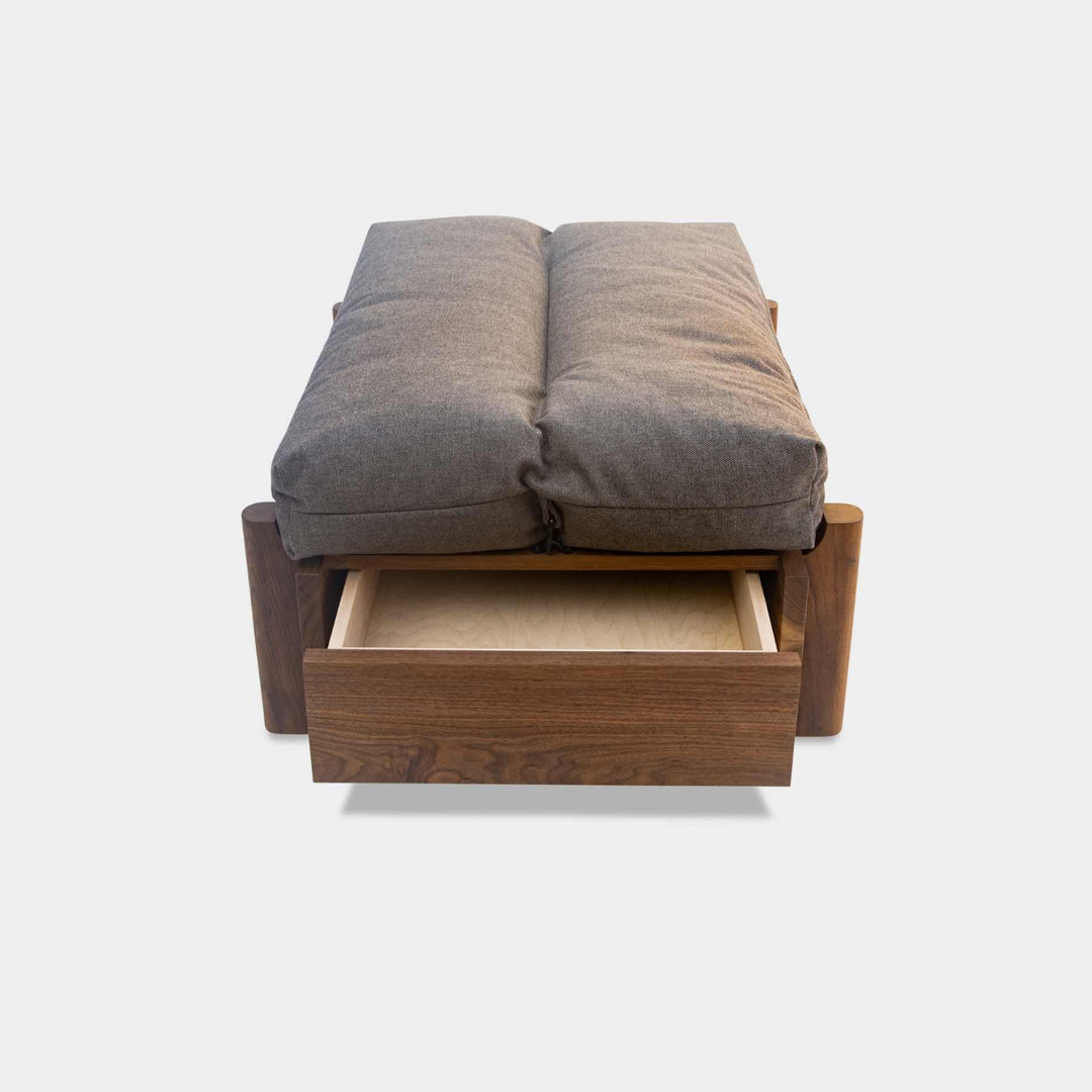 This EARL handmade dog bed has a solid wood base with a hidden drawer, and a custom detachable cushion upholstered in Sunbrella Blend Coal. We offer various fabrics and customers own fabric is encouraged as well. The base can be made in walnut, white oak, or ebonized oak and custom sizing is also available.