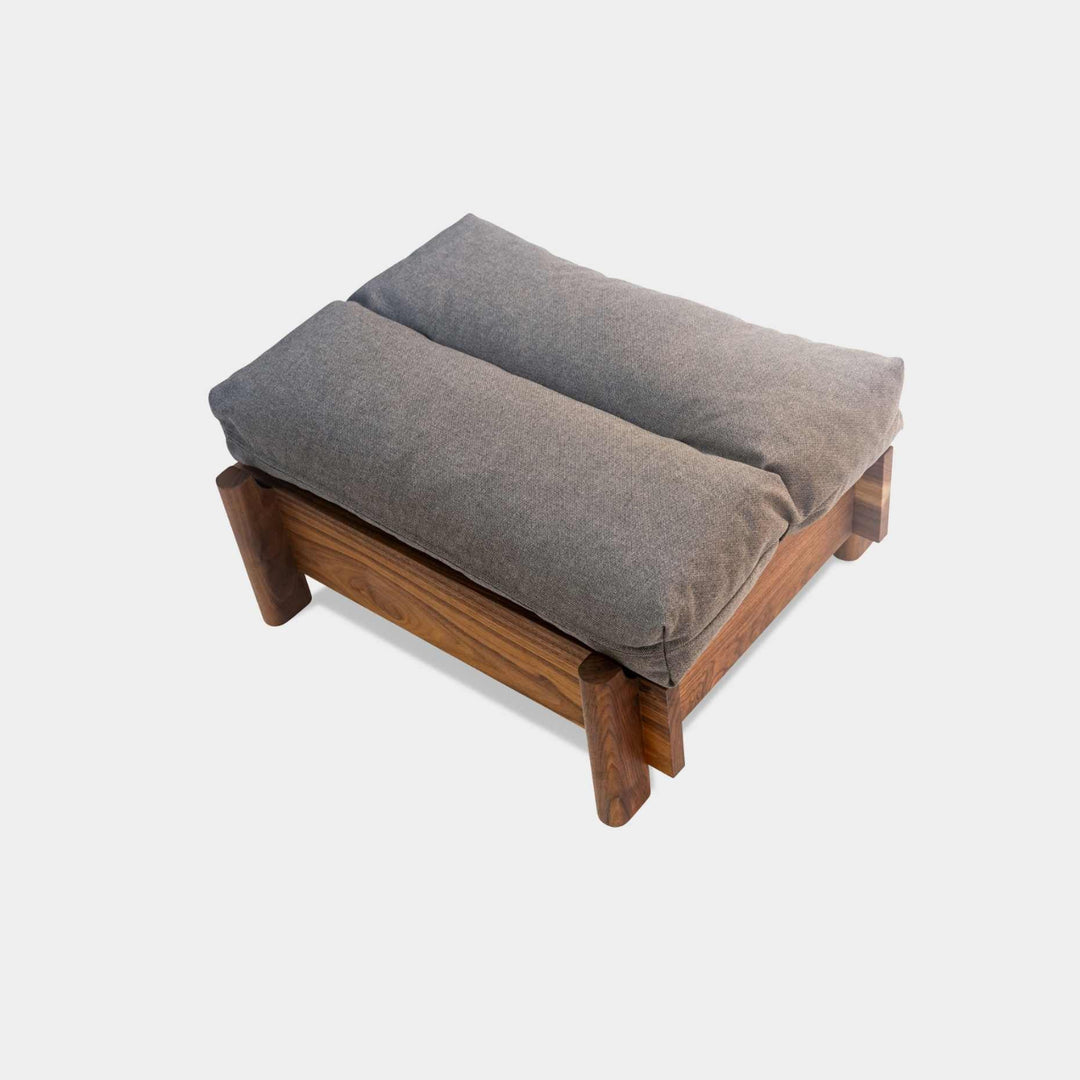 This EARL handmade dog bed has a solid wood base with a hidden drawer, and a custom detachable cushion upholstered in Sunbrella Blend Coal. We offer various fabrics and customers own fabric is encouraged as well. The base can be made in walnut, white oak, or ebonized oak and custom sizing is also available.