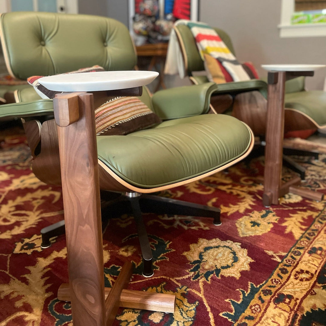 The Walnut MEDIA Side Table by Earl Home is a beautifully crafted nesting table featuring a solid wood construction with a round top and a custom-designed T-shaped base.