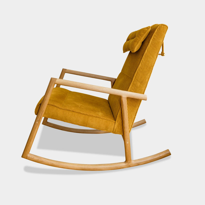Side view of the MORESBY Rocker by Earl Home. This handmade wooden rocking chair features white oak solid wood construction, kvdrat phlox custom upholstered seat, and an attached headrest.