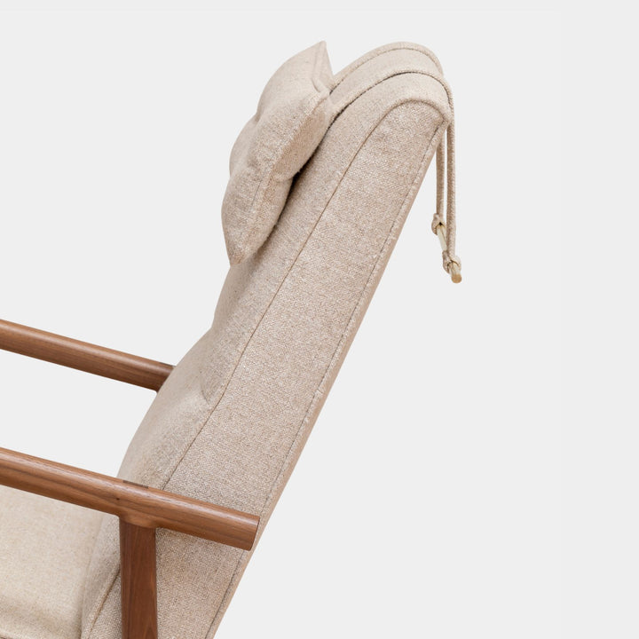 Side view of the MORESBY Rocker by Earl Home. This handmade wooden rocking chair features solid wood construction, cream linen cushions, a custom upholstered seat, and an attached headrest.