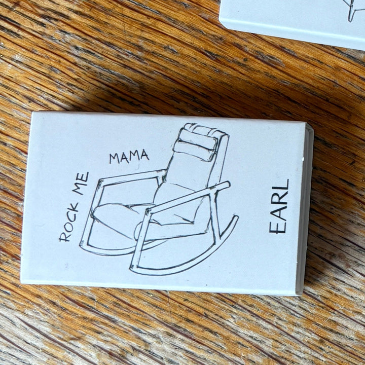 Small matchbook set. with illustrations and text on a wooden surface