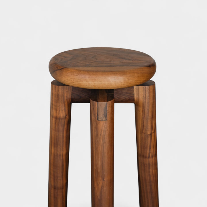 Solid walnut wood stool with a round seat that swivel screws up and down 5". Available in white oak, ebonized oak, white oak, and ash.