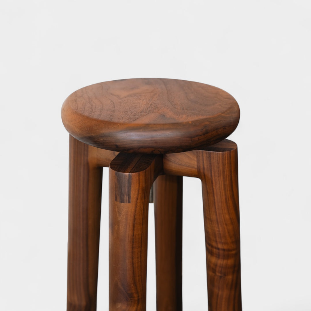 Solid walnut wood stool with a round seat that swivel screws up and down 5". Available in white oak, ebonized oak, white oak, and ash.