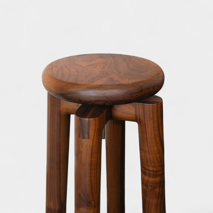 Solid walnut wood stool with a round seat that swivel screws up and down 5". Available in white oak, ebonized oak, white oak, and ash.
