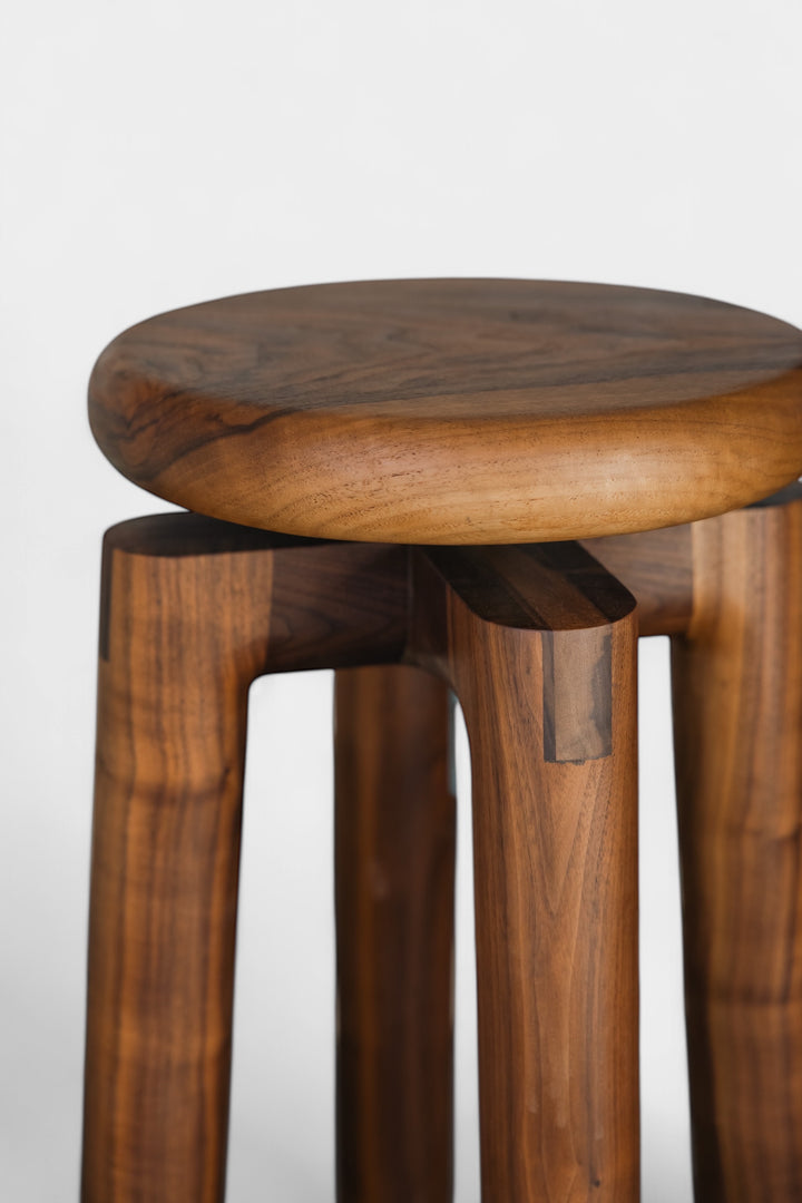 Solid walnut wood stool with a round seat that swivel screws up and down 5". Available in white oak, ebonized oak, white oak, and ash.
