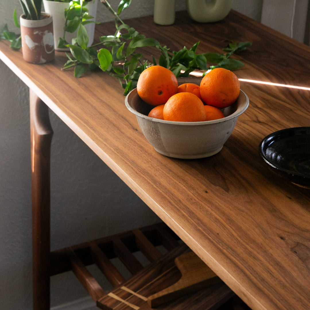 Solid Walnut wooden bread board or kitchen island with a slatted shelf for all of your cook books or produce baskets. 