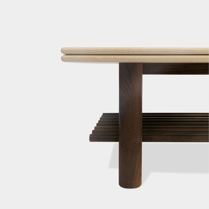 The sandstone top coffee table, featuring a refined double bullnose edge, showcases the stone’s natural beauty while adding a soft, sculpted touch. 
Supporting this stunning top is a sleek and sophisticated solid walnut base, meticulously crafted for both durability and style. 