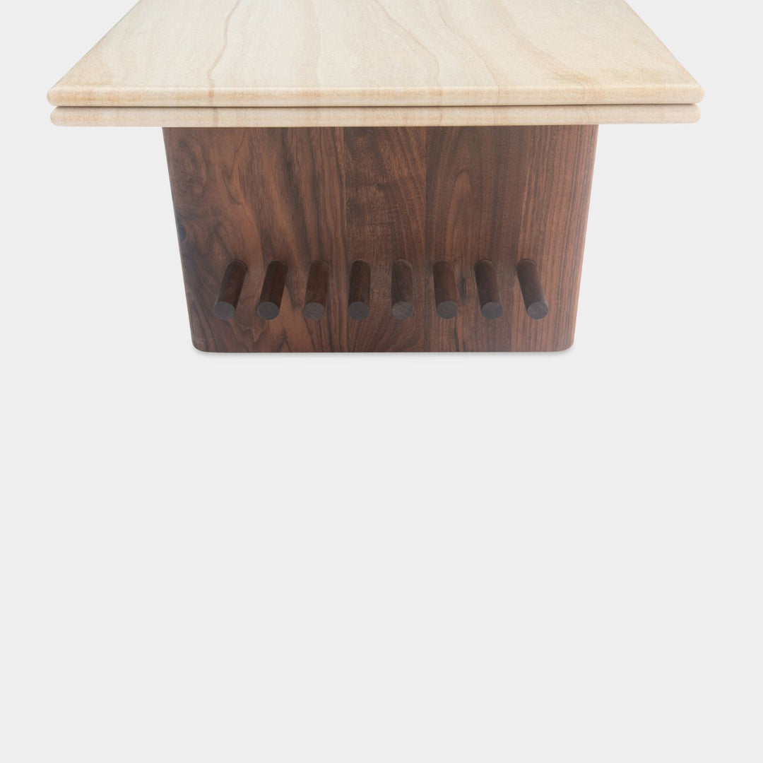 The sandstone top coffee table, featuring a refined double bullnose edge, showcases the stone’s natural beauty while adding a soft, sculpted touch. 
Supporting this stunning top is a sleek and sophisticated solid walnut base, meticulously crafted for both durability and style. 