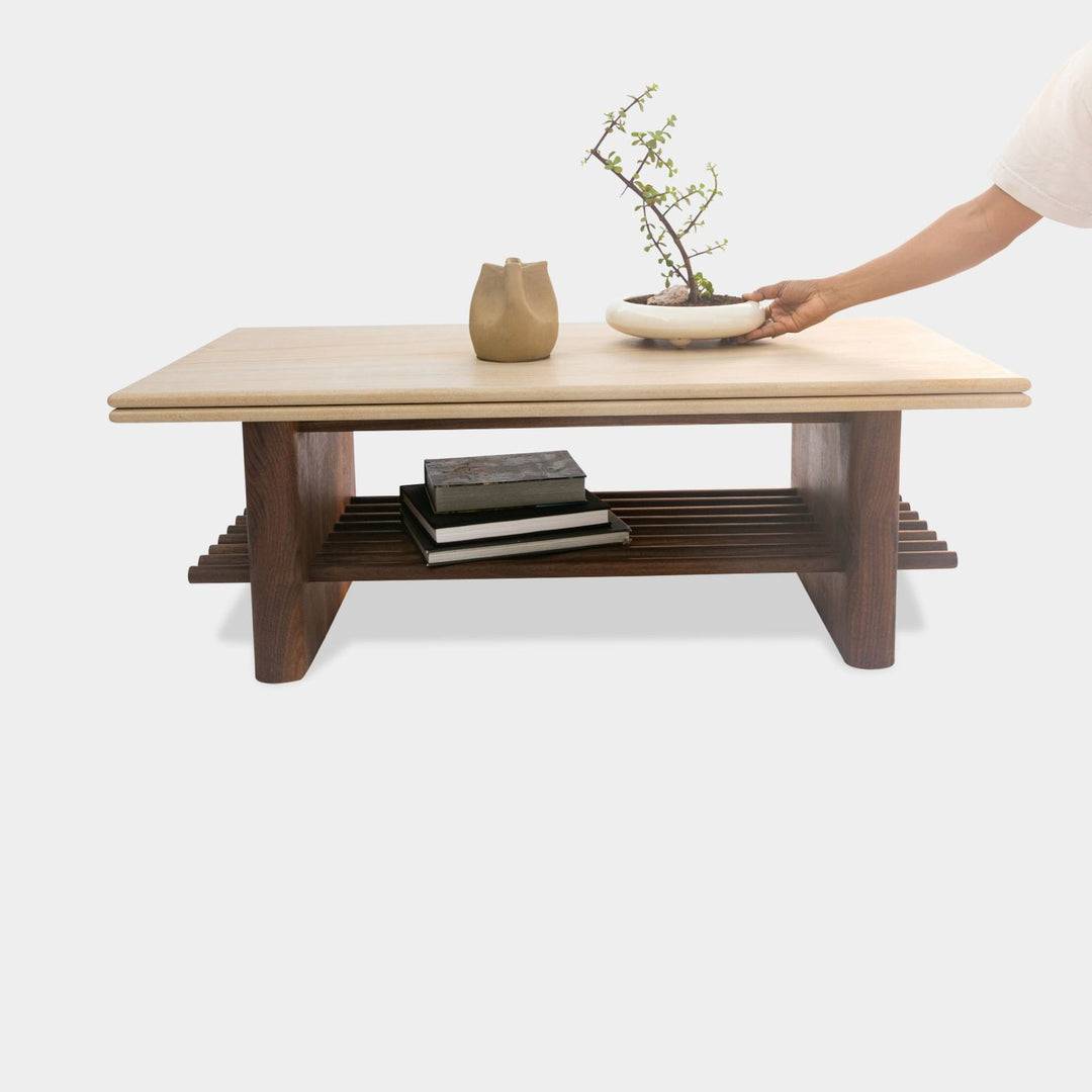 The sandstone top coffee table, featuring a refined double bullnose edge, showcases the stone’s natural beauty while adding a soft, sculpted touch. 
Supporting this stunning top is a sleek and sophisticated solid walnut base, meticulously crafted for both durability and style. 