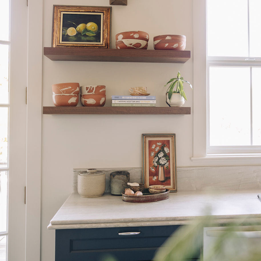 Terra Cotta Ceramic cereal bowls with cream splatter detail. Displayed on walnut kitchen shelves.