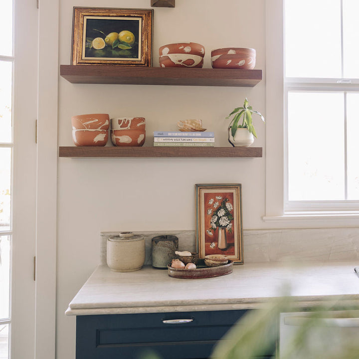 Terra Cotta Ceramic cereal bowls with cream splatter detail. Displayed on walnut kitchen shelves.