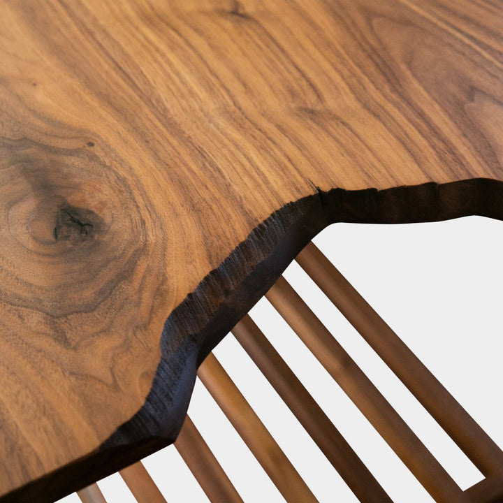 Close-up of a wooden bread board with a live edge detail on walnut