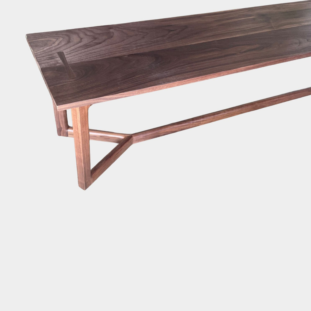 The WOLF Bench by Earl Home is a handcrafted piece with a natural finish and angular legs that highlight the beauty of solid wood top. Available in white oak, walnut or ebonized oak.