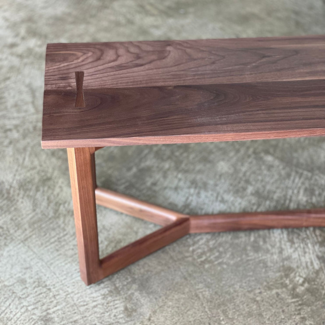 The WOLF Bench by Earl Home is a handcrafted piece with a natural finish and angular legs that highlight the beauty of solid wood top. Available in white oak, walnut or ebonized oak.