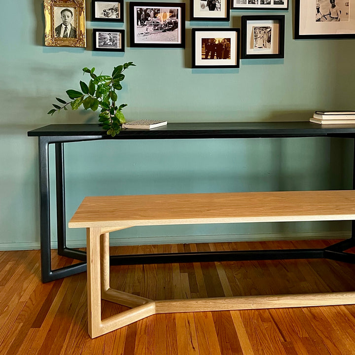 Black ebonized oak mid century modern console table with two lamps and interior designer decorative items. Perfect entry way table.