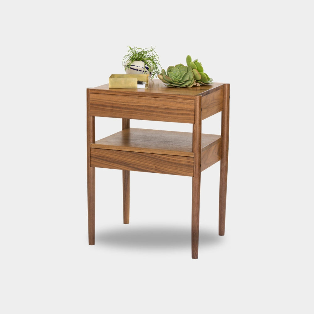 The Earl Home BEDSIDE Table is a solid wood nightstand featuring two open drawers, a minimalist design, and a natural finish. Custom sizing ensures it fits your space perfectly.