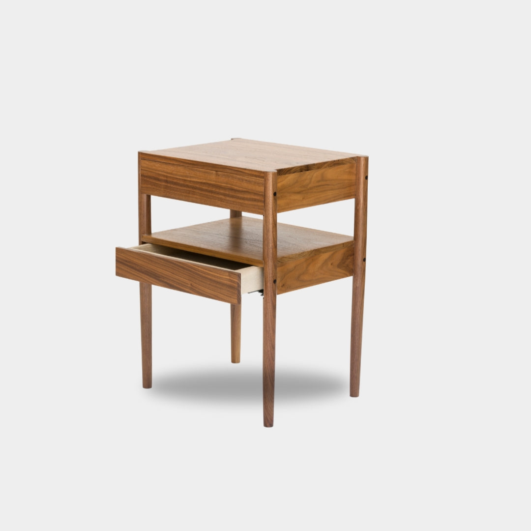 The Earl Home BEDSIDE Table is a solid wood nightstand featuring two open drawers, a minimalist design, and a natural finish. Custom sizing ensures it fits your space perfectly.