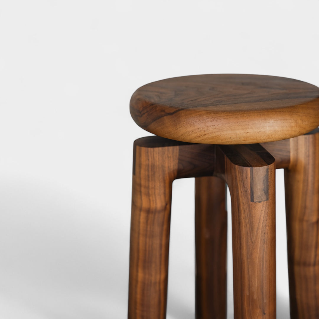 Solid walnut wood stool with a round seat that swivel screws up and down 5". Available in white oak, ebonized oak, white oak, and ash.