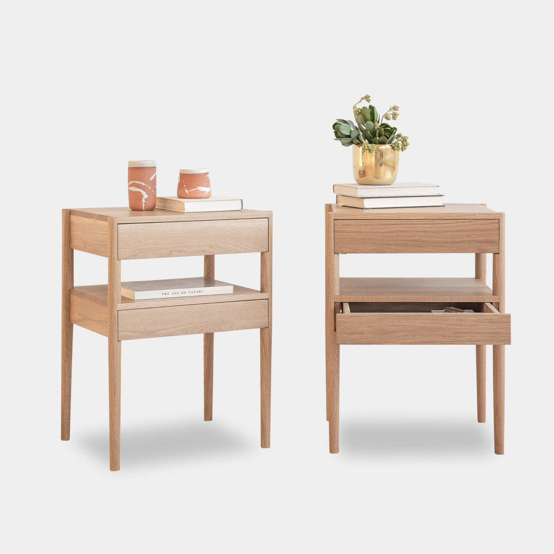 The Earl Home BEDSIDE Table is a solid wood nightstand featuring two open drawers, a minimalist design, and a natural finish. Custom sizing ensures it fits your space perfectly.