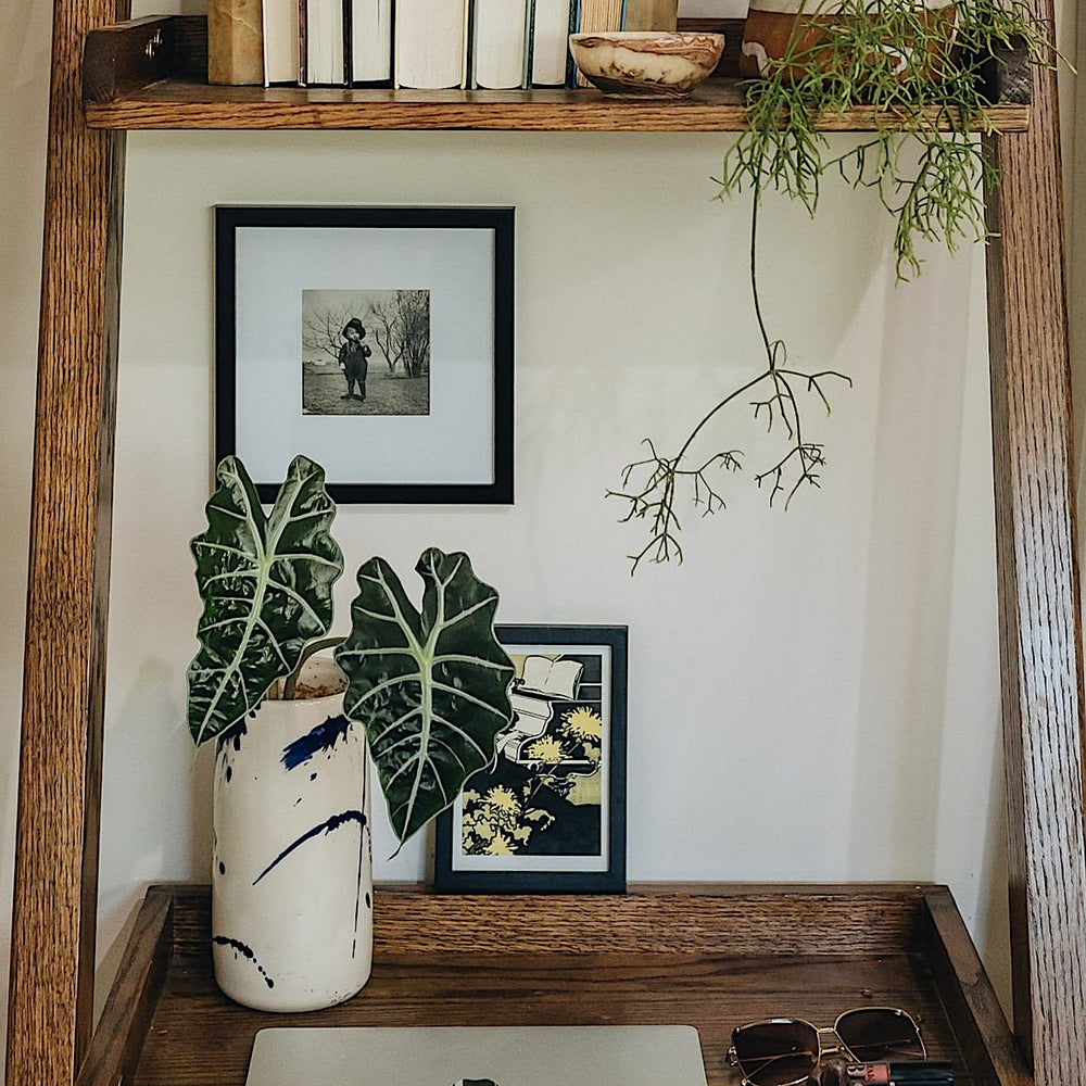 The TALL Cylinder cup by Earl Home features meticulous artistry with its hand-thrown white ceramic and abstract blue brushstrokes against a plain white background.