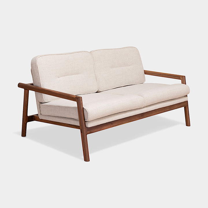 A side view of the MORESBY Love Seat by Earl Home, showcasing solid wood construction and off-white custom upholstered cushions against a plain background.