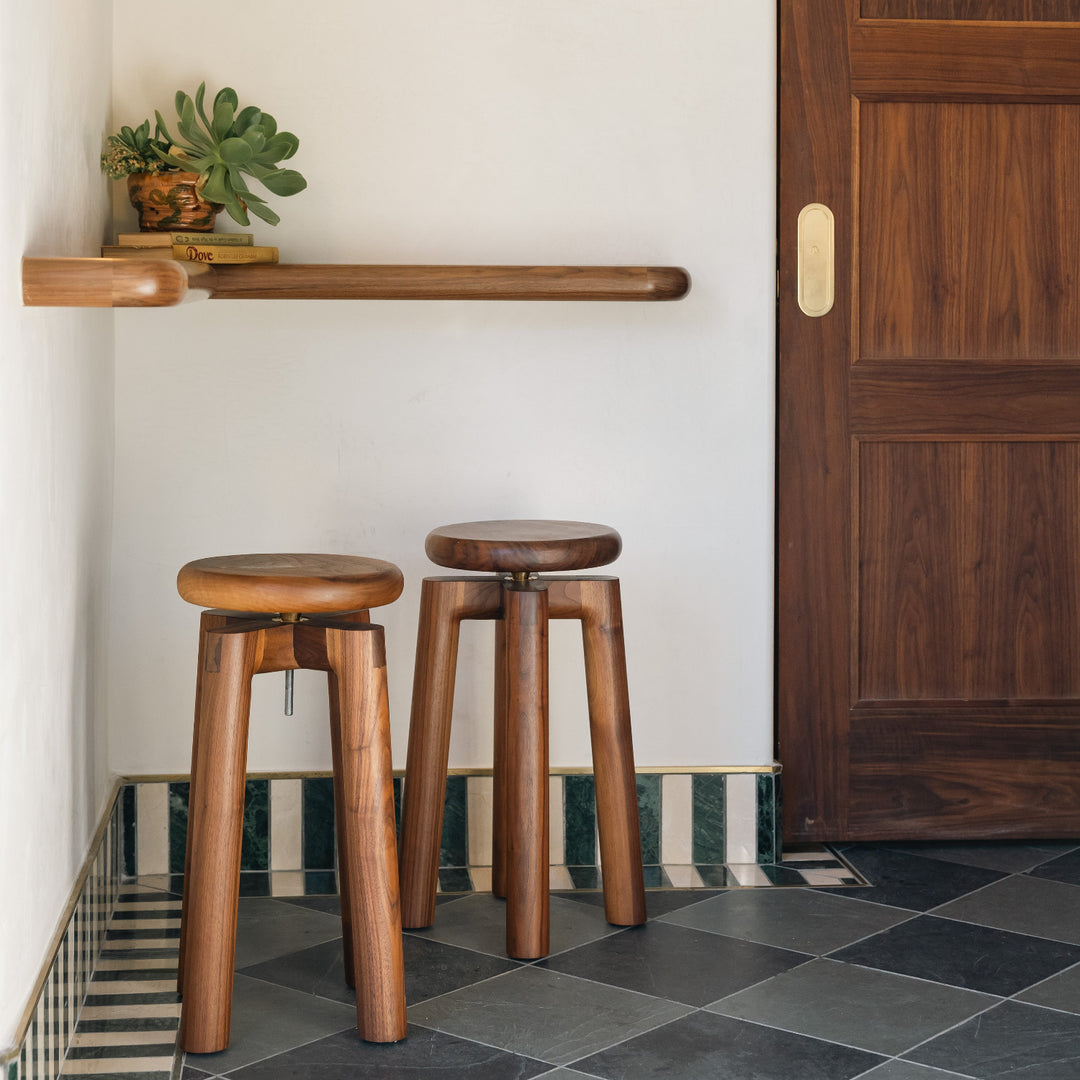 Solid walnut wood stool with a round seat that swivel screws up and down 5". Available in white oak, ebonized oak, white oak, and ash.