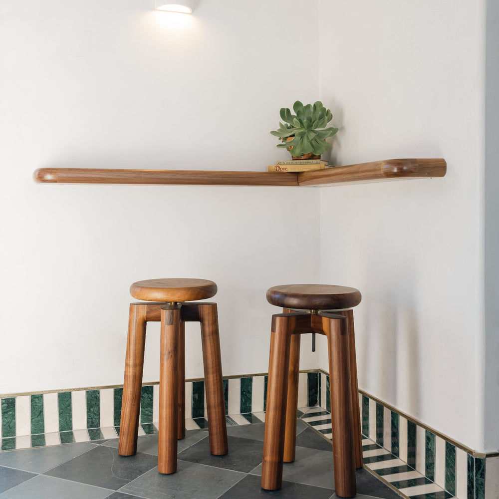 Solid walnut wood stool with a round seat that swivel screws up and down 5". Available in white oak, ebonized oak, white oak, and ash.