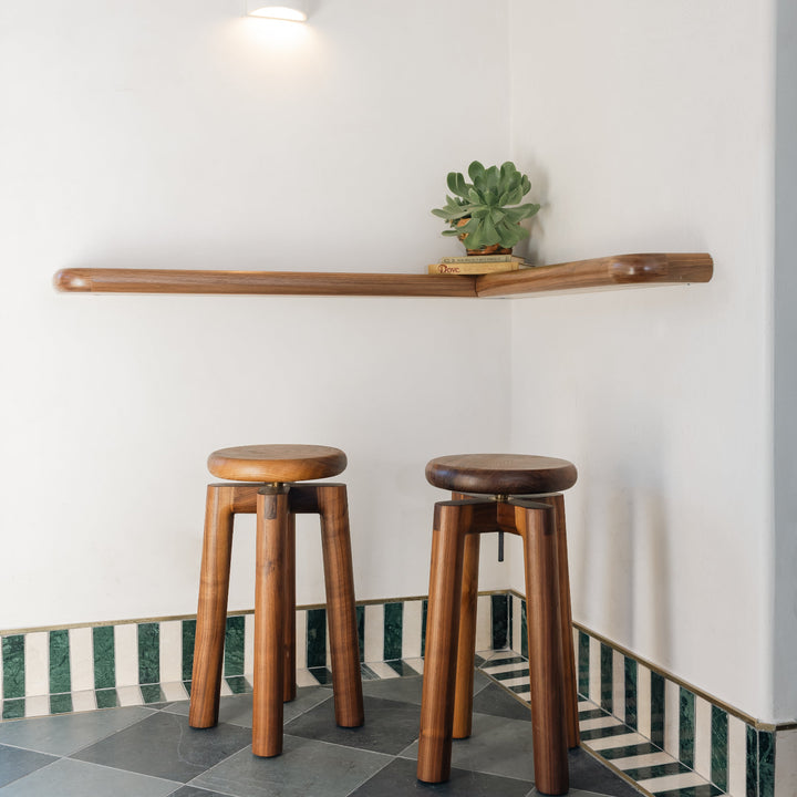 Solid walnut wood stool with a round seat that swivel screws up and down 5". Available in white oak, ebonized oak, white oak, and ash.