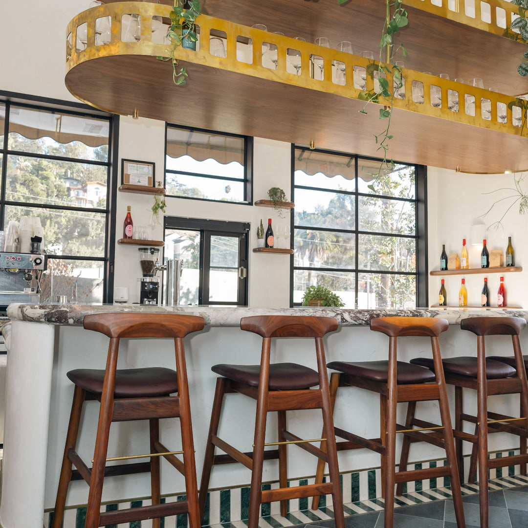 EARL Interiors featuring Reunion & Co with our sable barstool in walnut and mixed marble stone tile and wine bar and coffee shop.