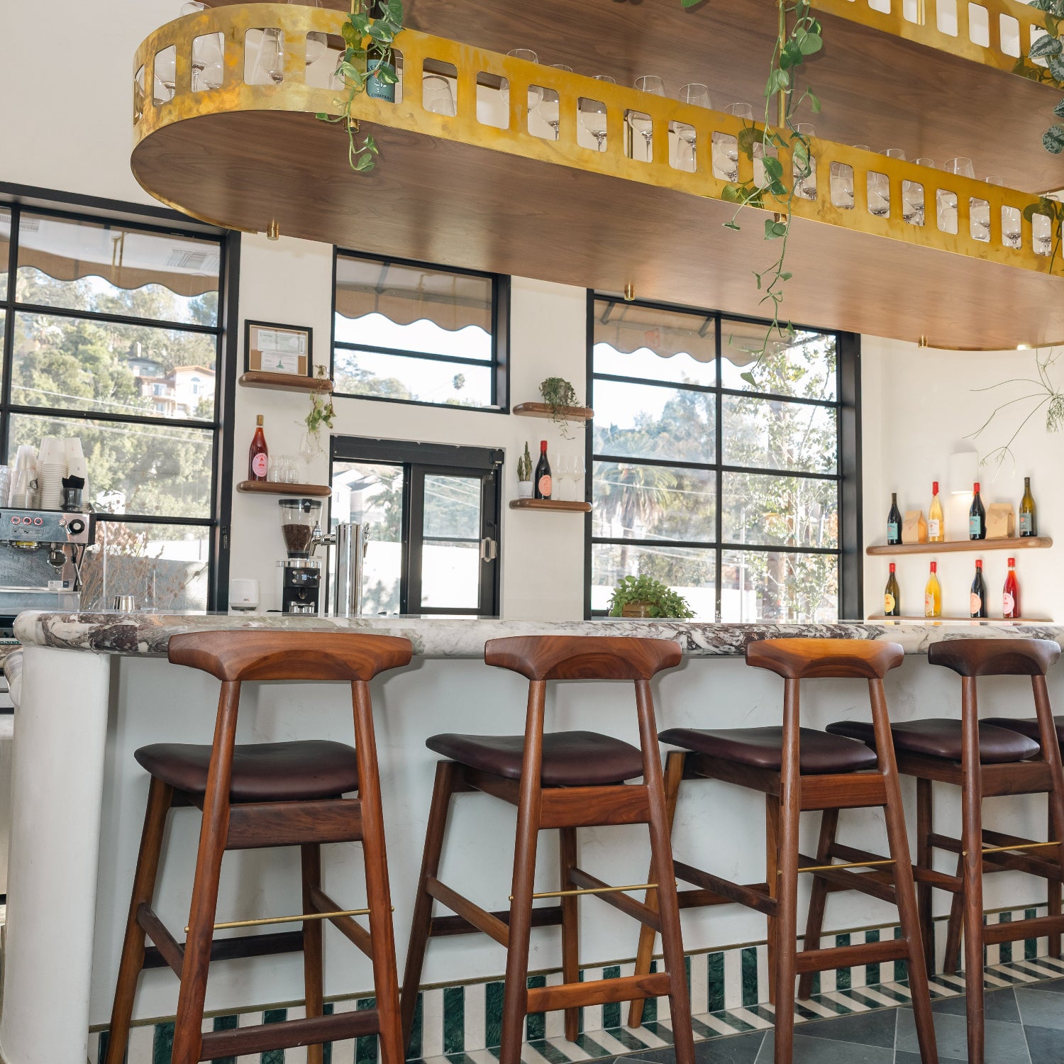 EARL Interiors featuring Reunion & Co with our sable barstool in walnut and mixed marble stone tile and wine bar and coffee shop.
