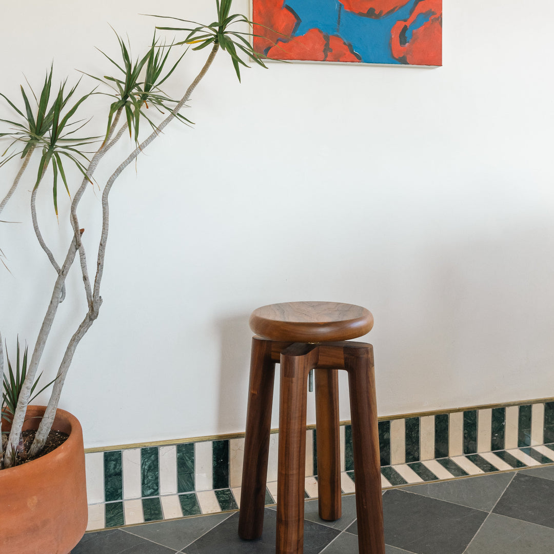 Solid walnut wood stool with a round seat that swivel screws up and down 5". Available in white oak, ebonized oak, white oak, and ash.