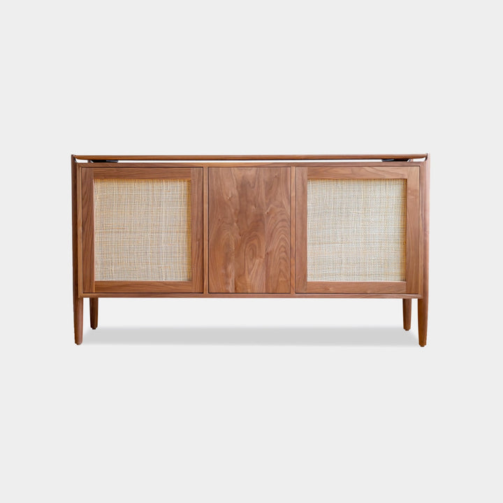 The KABOT Sideboard (Low) by Earl Home is a wooden mid-century modern dresser, featuring two woven panels and slender legs, exemplifying heritage quality design.