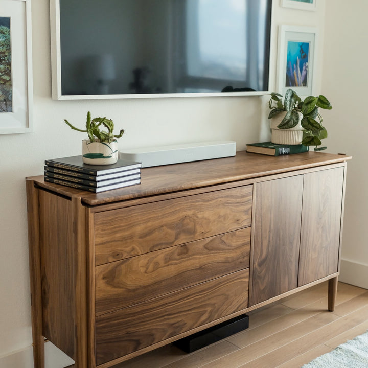 The KABOT Sideboard (Low) by Earl Home is a wooden mid-century modern dresser, featuring two woven panels and slender legs, exemplifying heritage quality design.