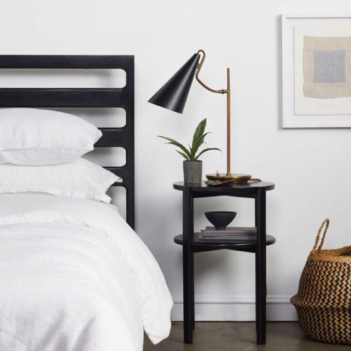 Solid wood ebonized oak handmade bedframe and black bedside table. The double tiered nightstand is perfect for bedside storage in your bedroom. Hand crafted in Los Angeles, California.