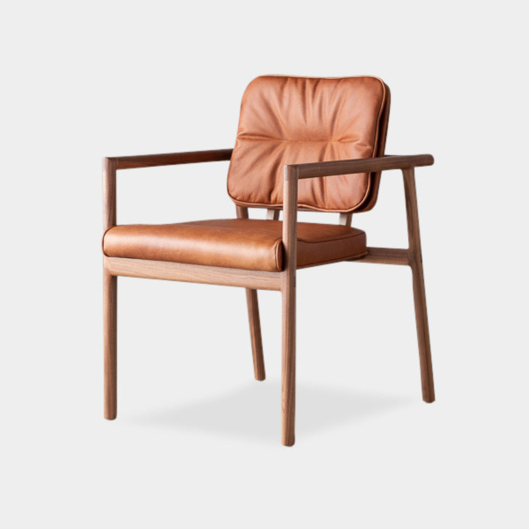 The MORESBY Captain Chair by Earl Home is hand-made with a custom upholstered camel leather seat that is a rich brown leather and walnut solid wood, set against a white background.