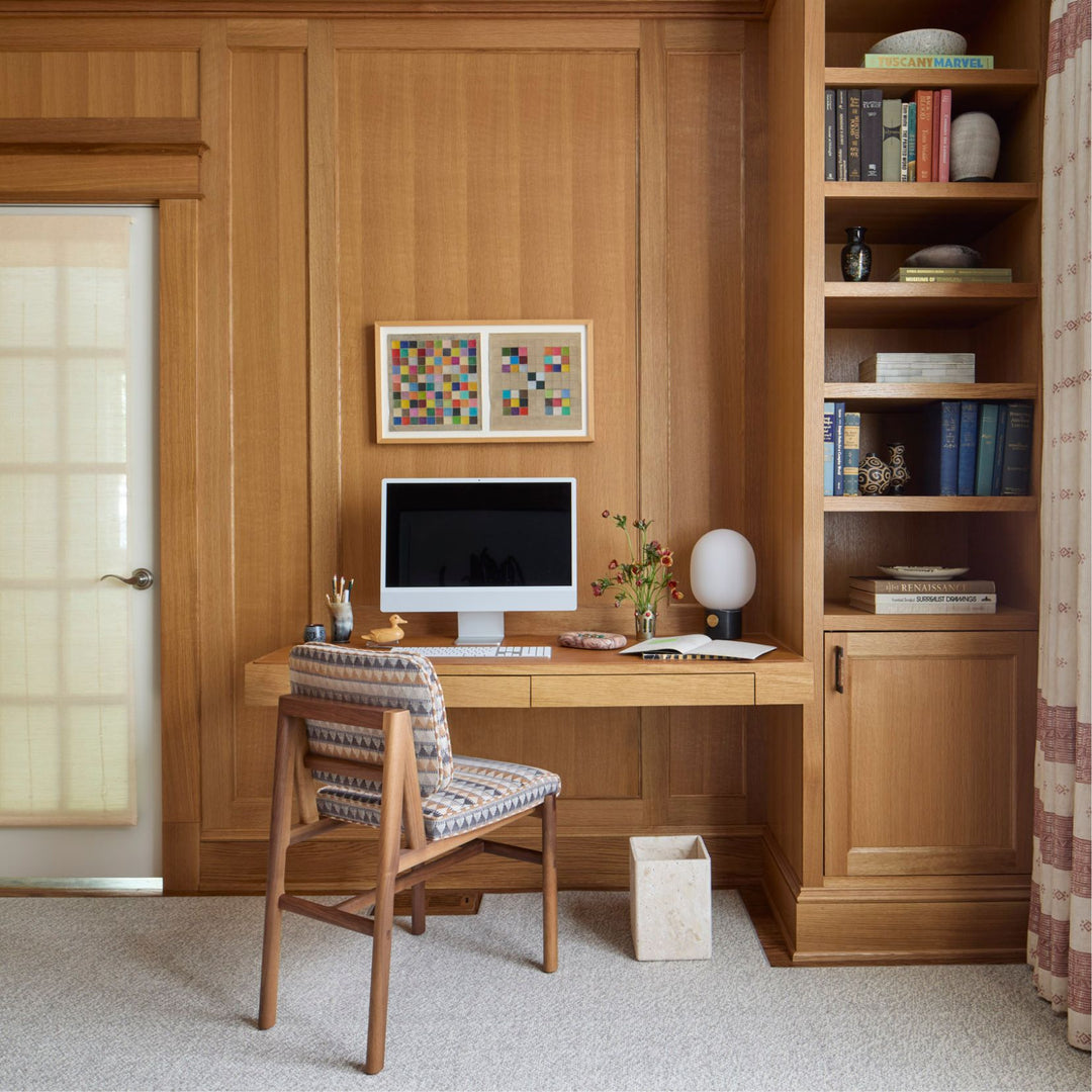 The MORESBY Dining Chair by Earl Home features a custom upholstered printed fabric seat and backrest, elegantly crafted on a solid wood walnut frame with simple, angular lines.