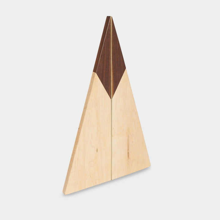 The TRIANGLE Cheese Board by Earl Home is a stylish centerpiece with a triangular design. It is solid walnut and maple featuring a brass spline. Perfect for your cheeseboard or charcuterie spread.