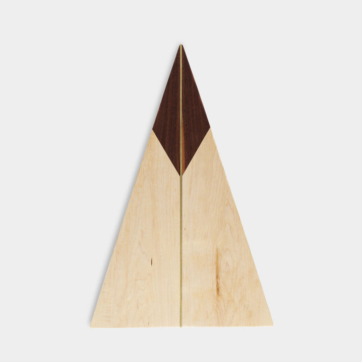 The TRIANGLE Cheese Board by Earl Home is a stylish centerpiece with a triangular design. It is solid walnut and maple featuring a brass spline. Perfect for your cheeseboard or charcuterie spread.