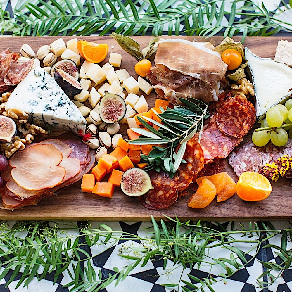 The Rectangle Cutting Board by Earl Home is a wooden board featuring a natural oak grain pattern with two parallel walnut inlays near one end.