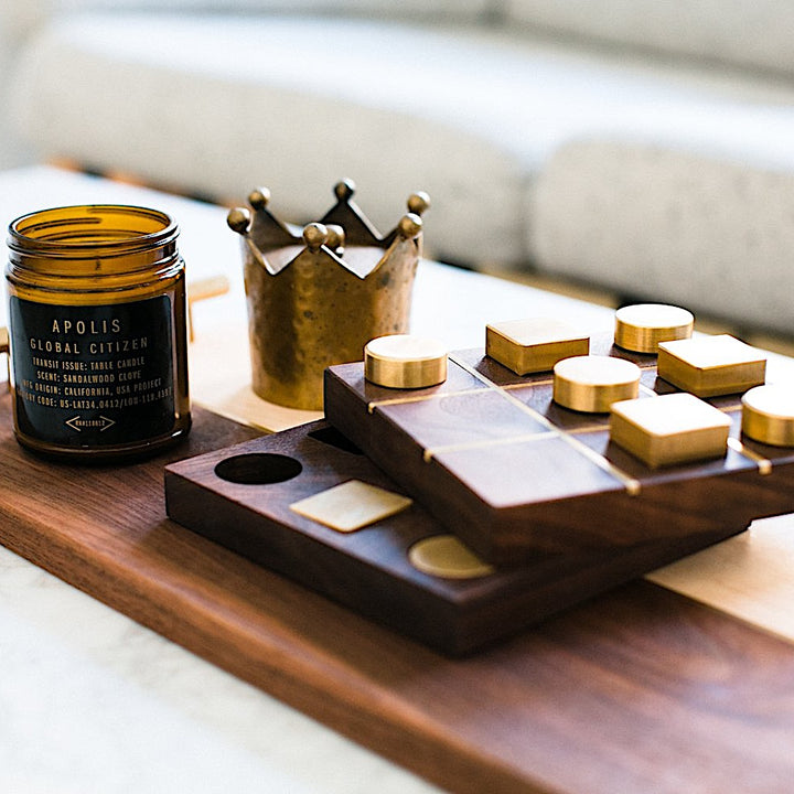 The RECTANGLE Service Tray by Earl Home is a handcrafted, two-tone wooden serving board with elegant brass handles, featuring a light and dark wood design akin to a classic brass tray.