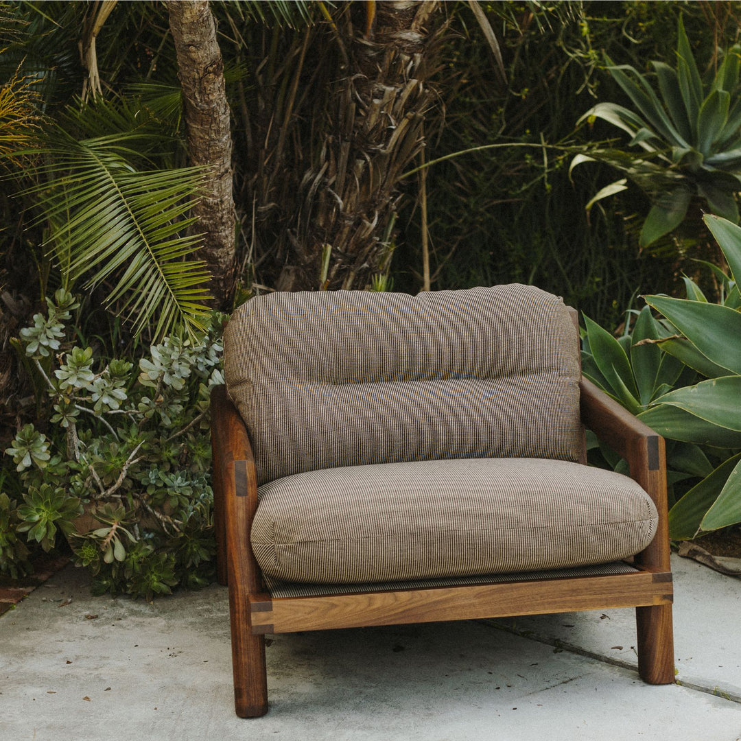 The Earl Home Walnut TAMBU Lounge Chair boasts kvdrat fuse striped fabric upholstery, a sturdy walnut frame, and plush down cushioned seat and backrest gives the ultimate cozy hygge vibe.