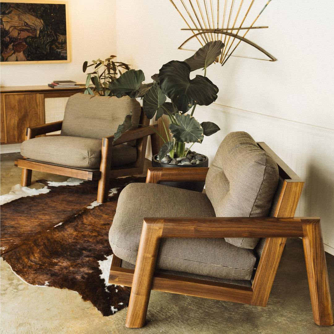 The Earl Home Walnut TAMBU Lounge Chair boasts kvdrat fuse striped fabric upholstery, a sturdy walnut frame, and plush down cushioned seat and backrest gives the ultimate cozy hygge vibe.
